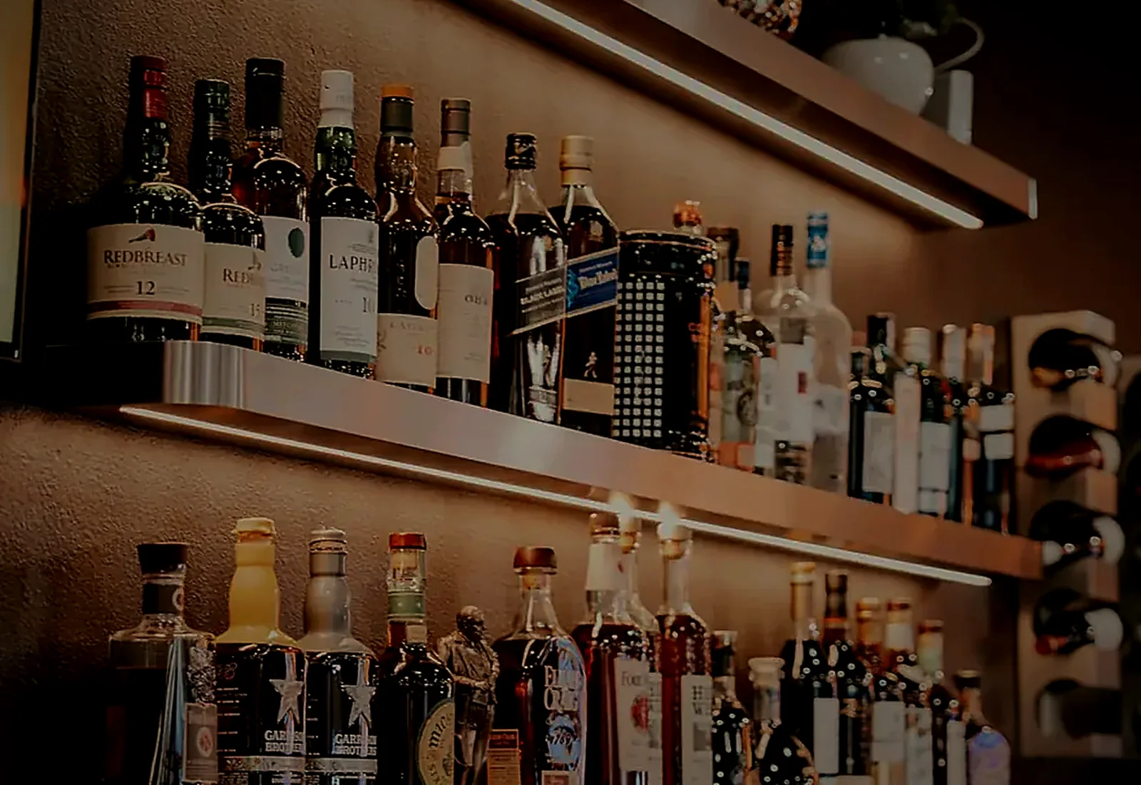 The back bar, lit shelves of whisky and bourbon